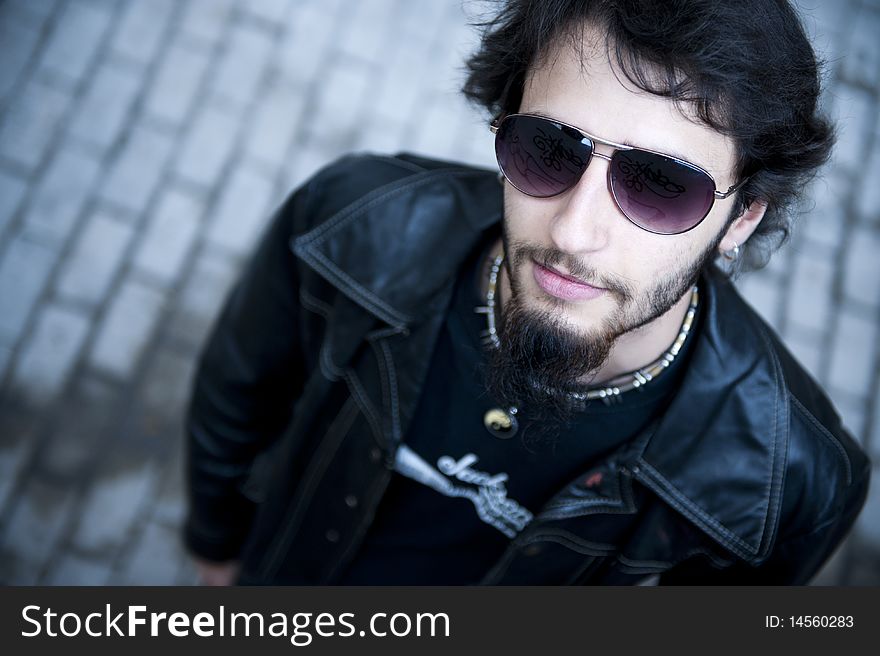 Young handsome musician in urban background. Young handsome musician in urban background