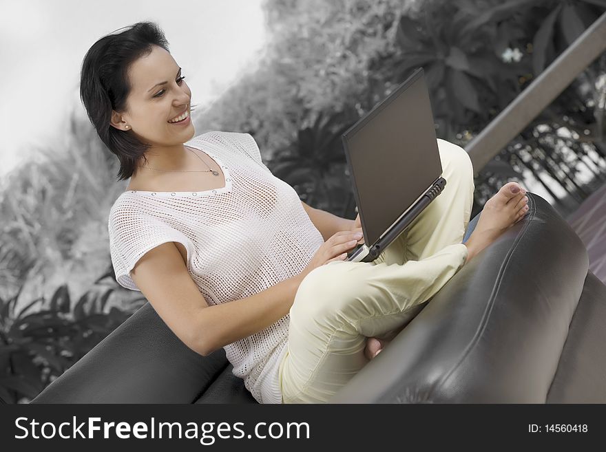 Portrait of woman with laptopm in summer environment