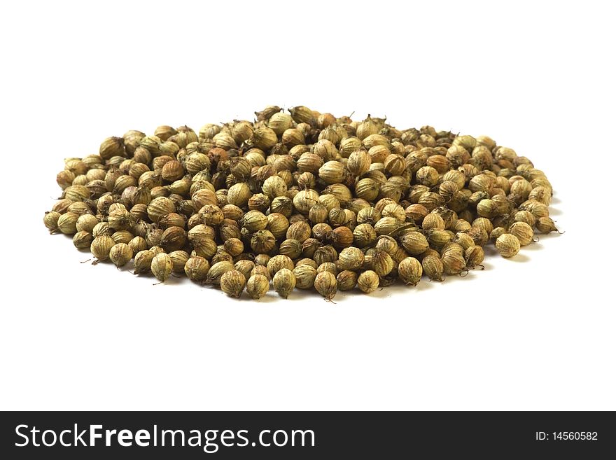 Pile of coriander seeds isolated on white background