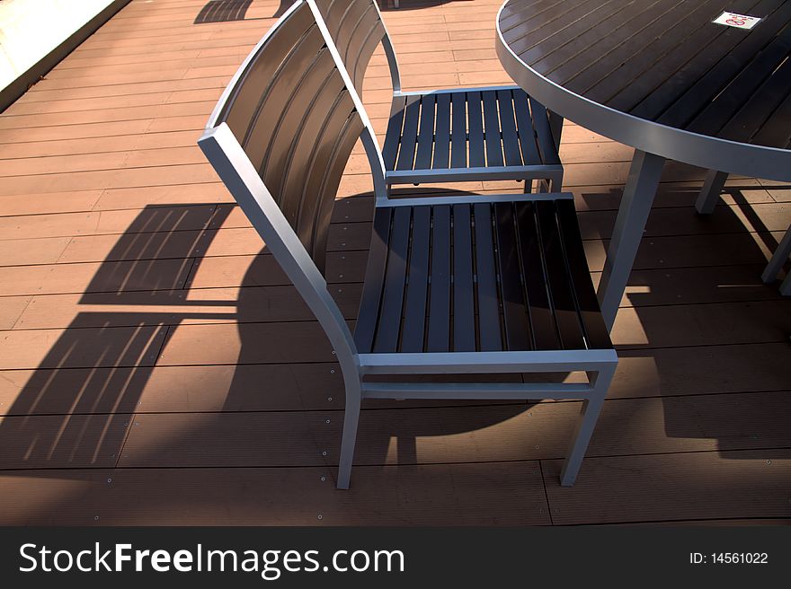 Lounge chairs at sunset on a resorts  deck .