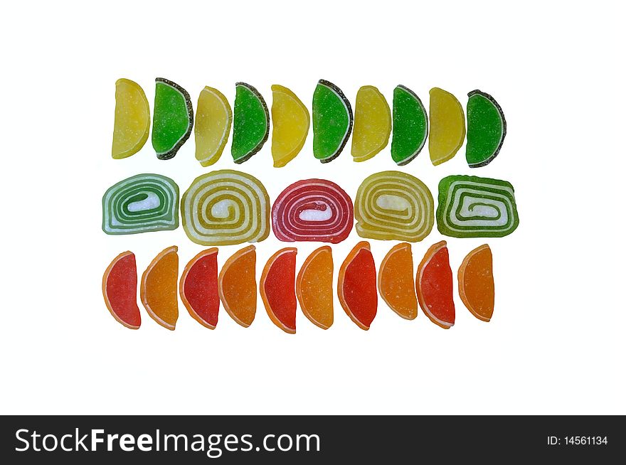 Sugar-coated jelly candy in four colors in the form slices and rolls. Photography. Sugar-coated jelly candy in four colors in the form slices and rolls. Photography