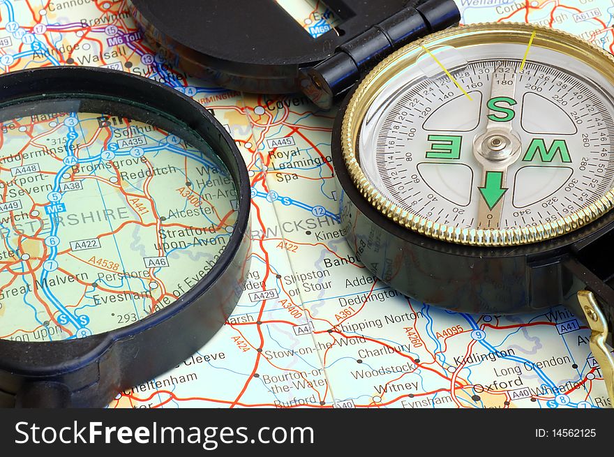 Compass and magnifier on a map for travel by close up. Compass and magnifier on a map for travel by close up