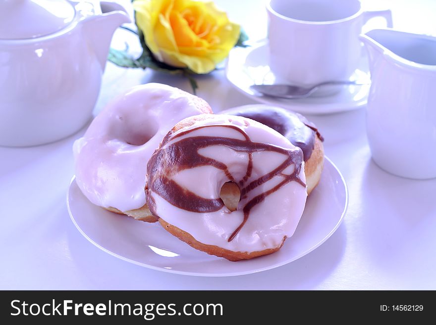 Chocolate and vanilla doughnuts and tea