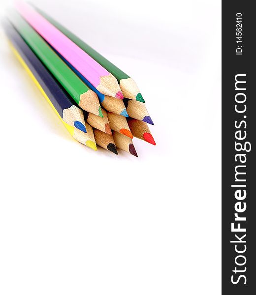 The wooden colour pencils piled