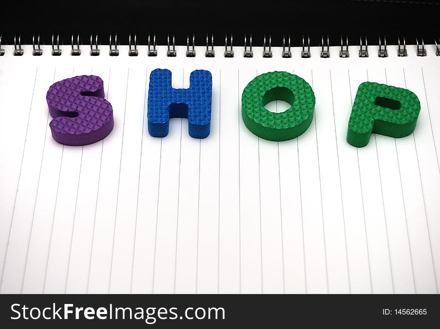 Wording shop on opened notebook. Wording shop on opened notebook