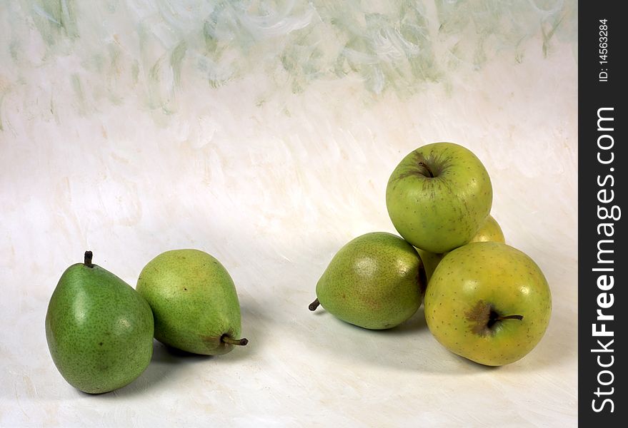 Green pears and apples isolated on painted background