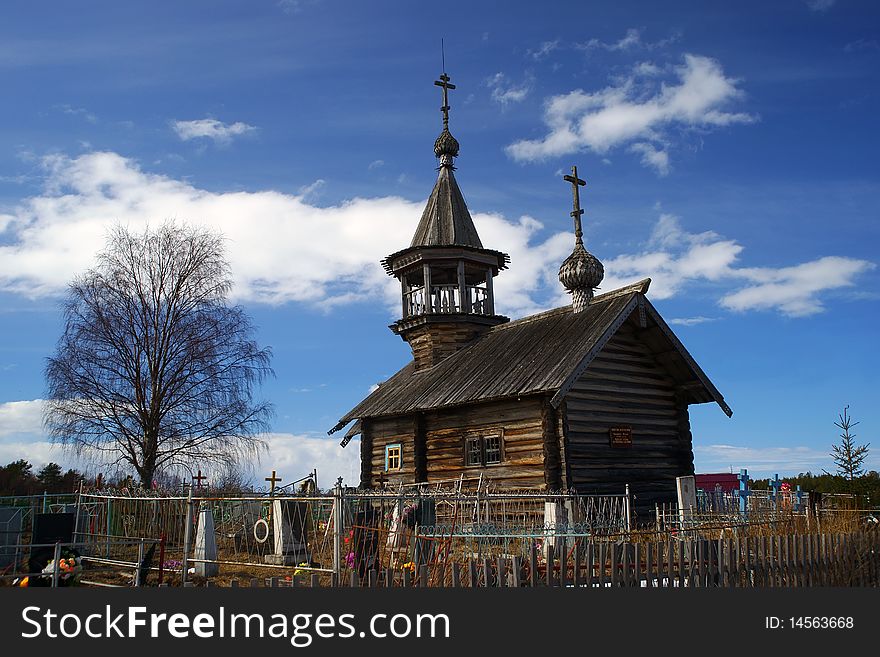 The old wooden church on rustic graveyard. The Chapel Ilii, village Pyalima, Kareliya. 18 age. Russian north