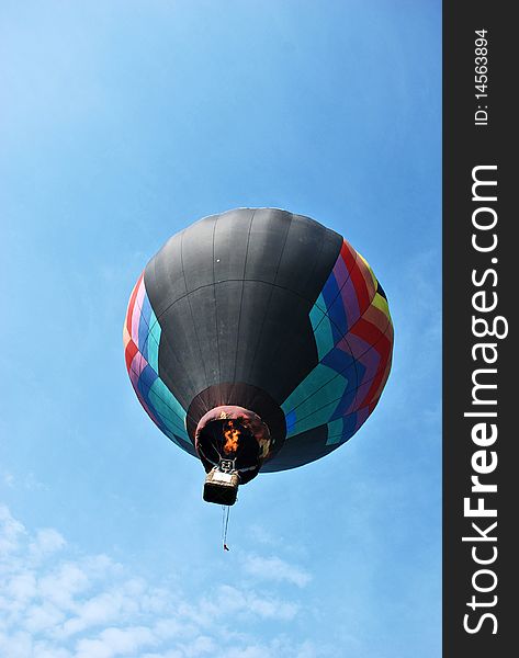 Hot air balloon with flames on the sky