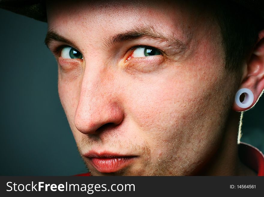 Close-up of a young man in hat
