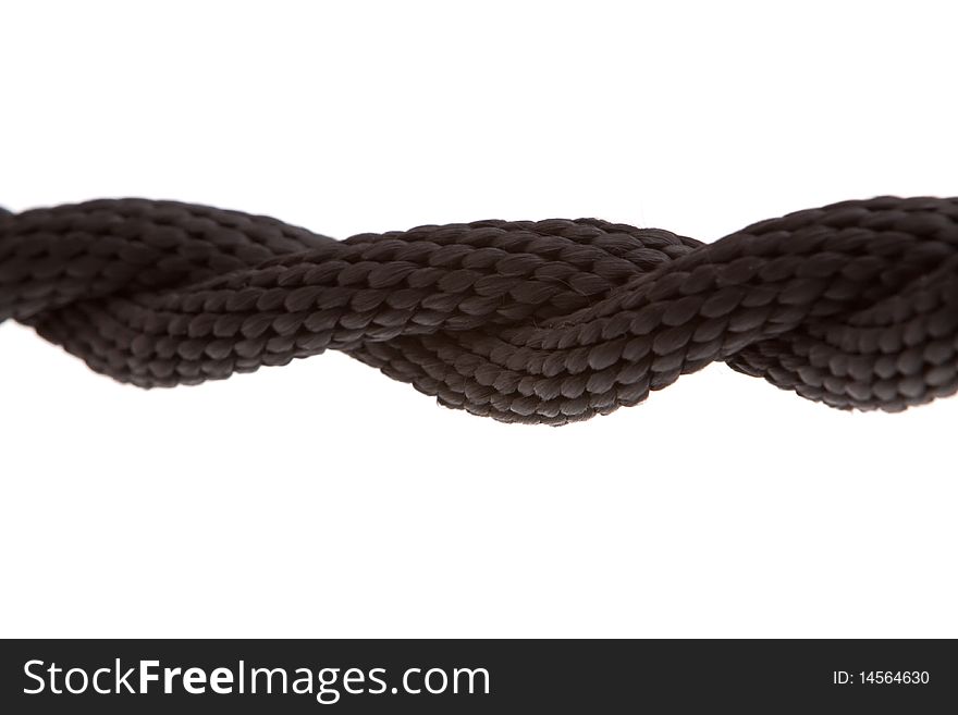 Twisted black rope on white background