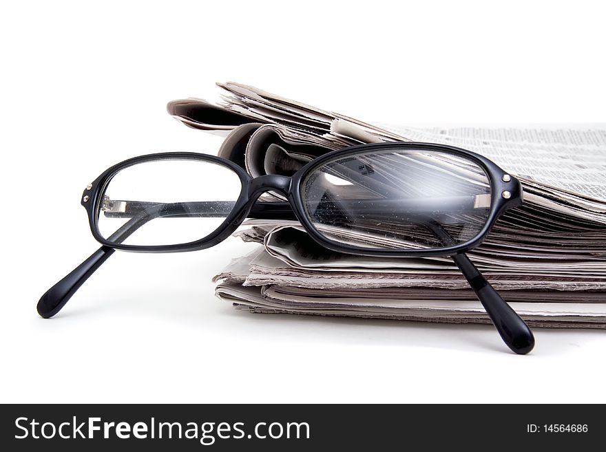 Reading glasses on stack of newspaper. Reading glasses on stack of newspaper