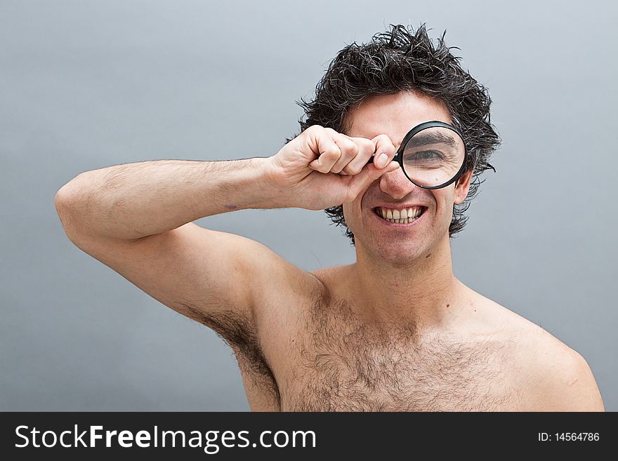 Curious man examining with magnifying glass. Curious man examining with magnifying glass