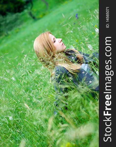 Beautiful teen blond girl staying in the meadow. Beautiful teen blond girl staying in the meadow