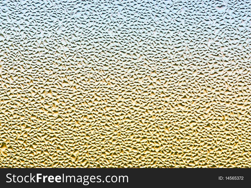 Water drops on metalized car paint, hence the tiny grain-looking dots on the surface