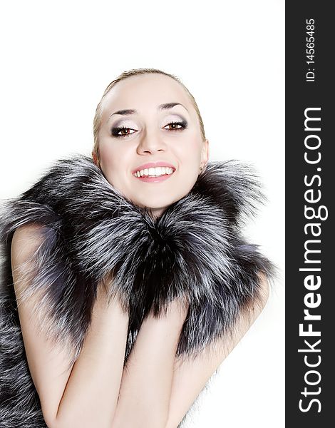 Young beautiful woman in fur over white