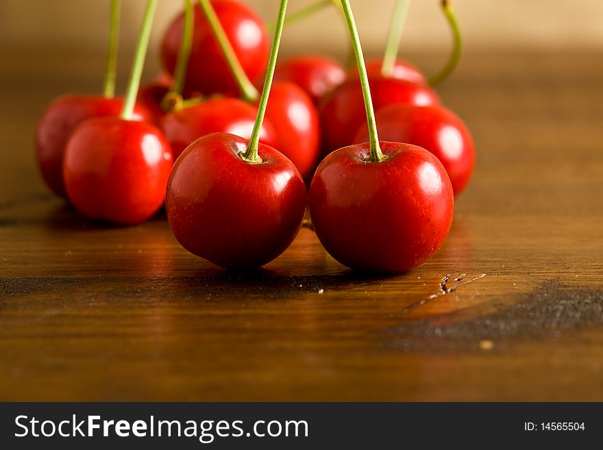 Beautiful close-up photography of red cherries putted on a wood table