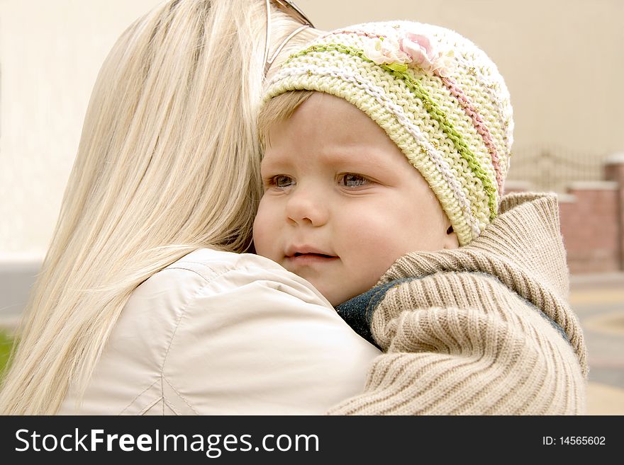 Mum embraces and calms the tear-stained child. Mum embraces and calms the tear-stained child