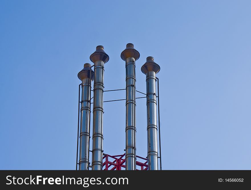 Four CHimney Pipes on a blue sky background