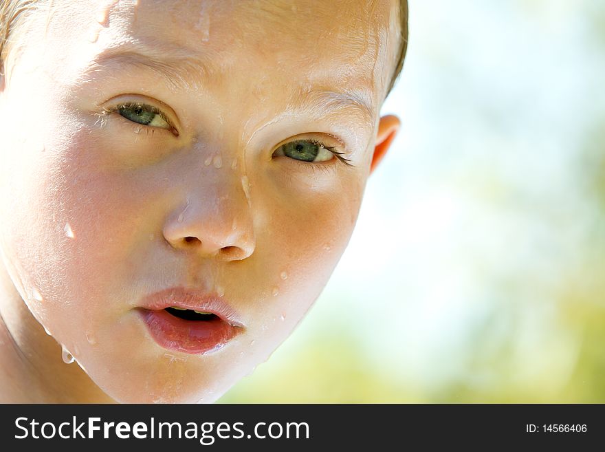 Portrait of a young child with water drop on face