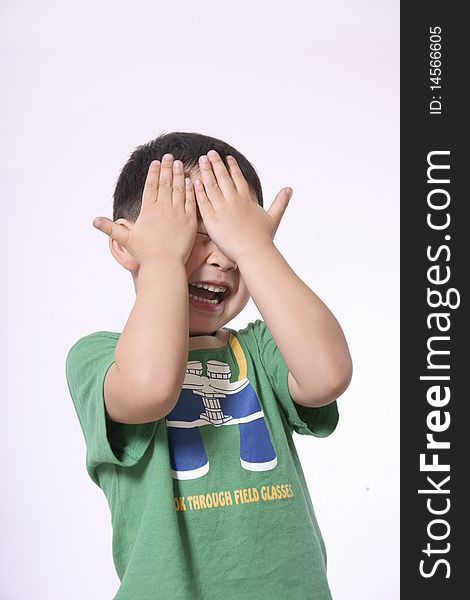 Laughing boy covering face with hands