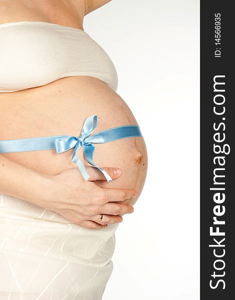 Pregnant girl with a blue ribbon tied on the stomach