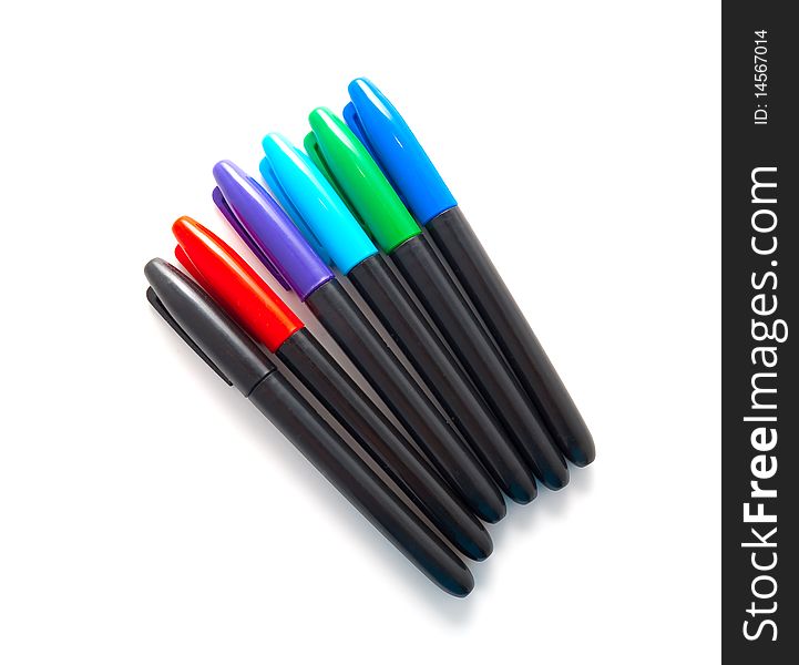 Set of multi-coloured pens on a white background