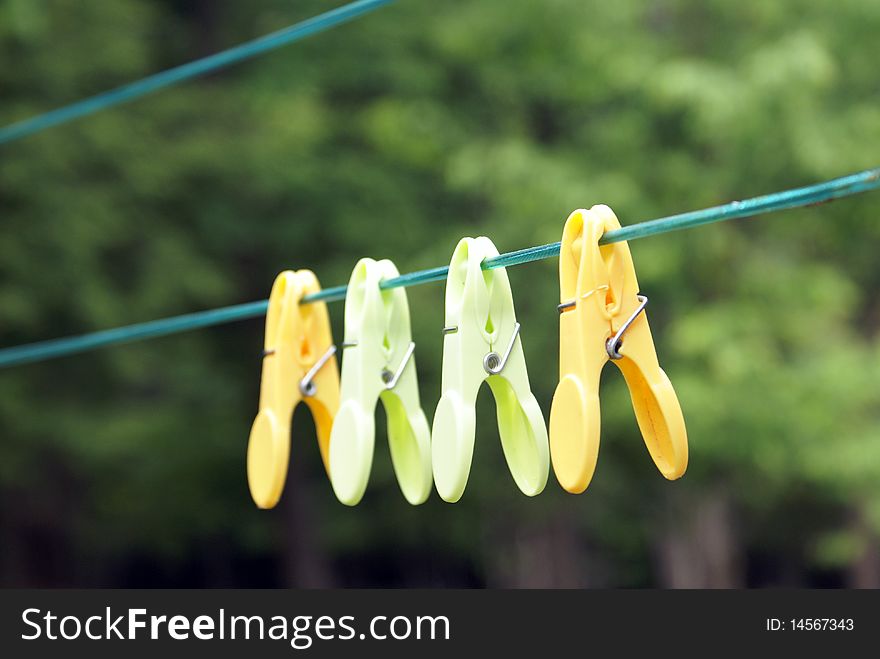 A few clothespins hanging on the line.
