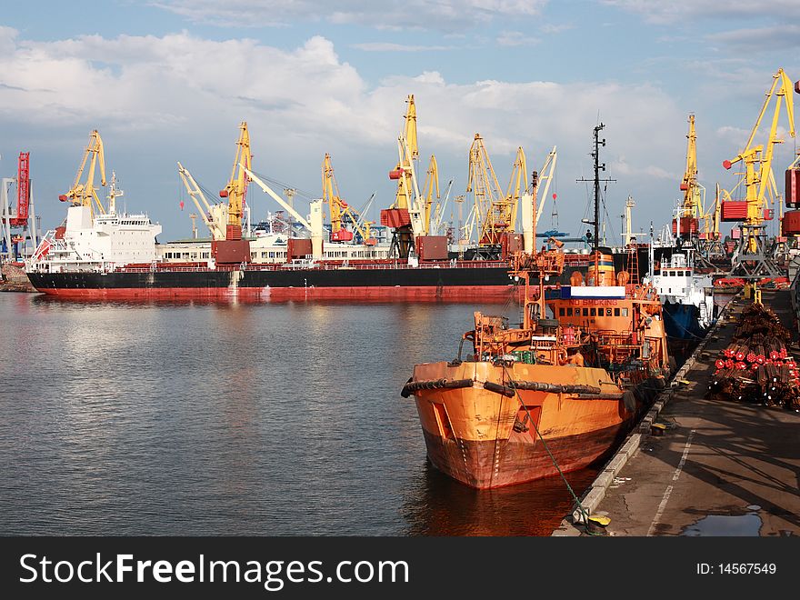 View of trading port with cargo ships and cranes