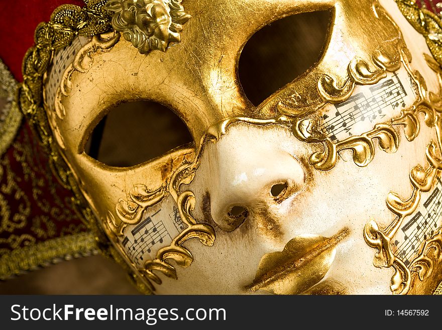 Photo of a venice carneval mask putted on a wood table. Photo of a venice carneval mask putted on a wood table