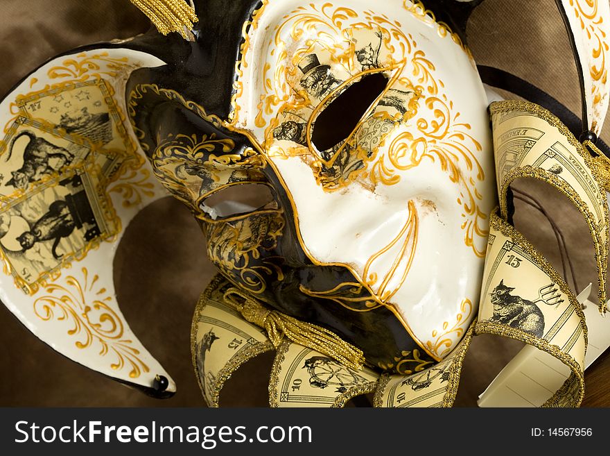 Photo of a venice carneval mask putted on a wood table. Photo of a venice carneval mask putted on a wood table