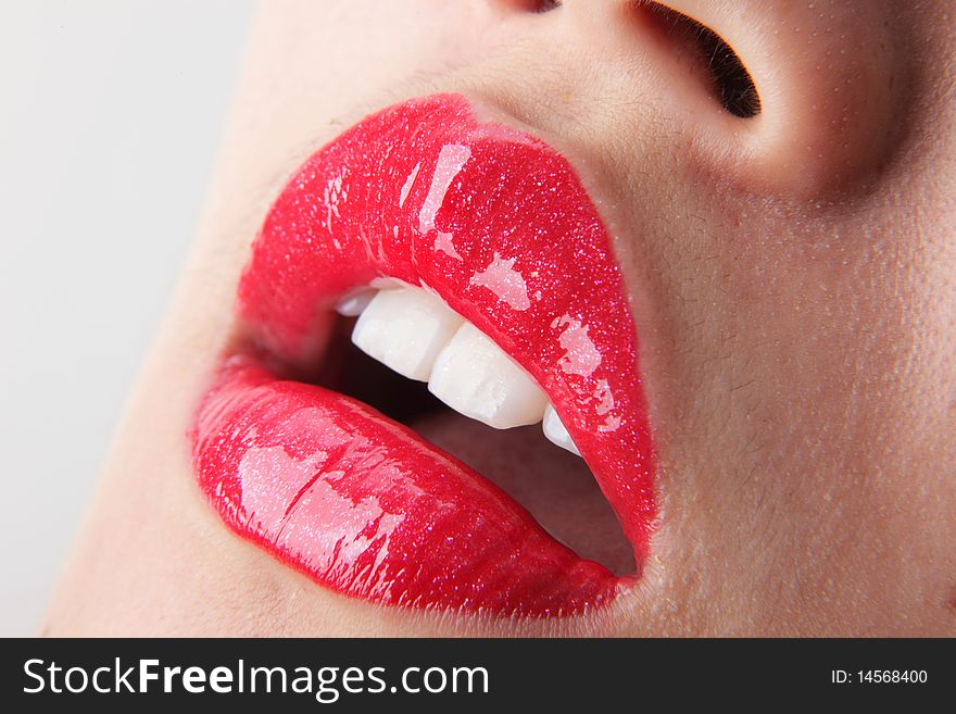 Female lips with red lip gloss