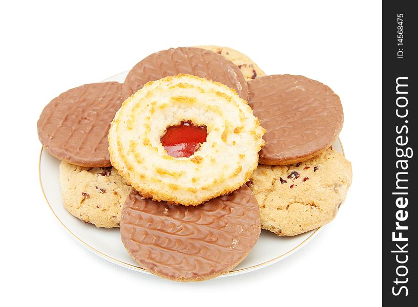 Fruit and jam cookies with chocolate biscuits on a plate. Isolated over white background. Fruit and jam cookies with chocolate biscuits on a plate. Isolated over white background.