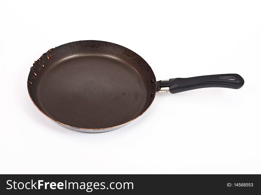 Empty frying pan isolated over white