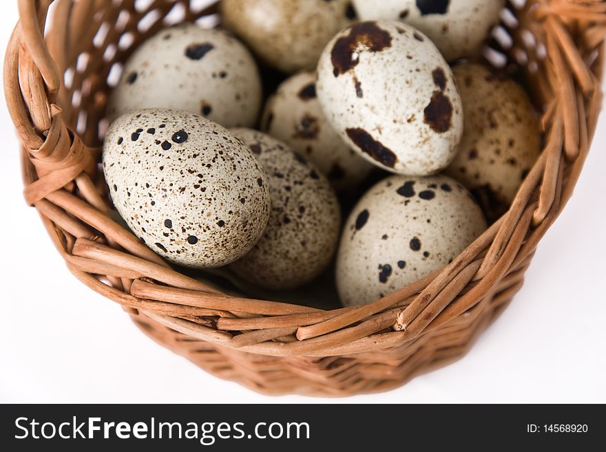 Quail eggs in a basket, top view