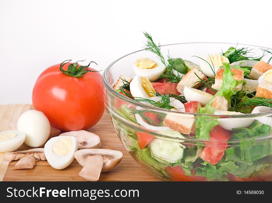 Fresh raw vegetable salad in glass bowl