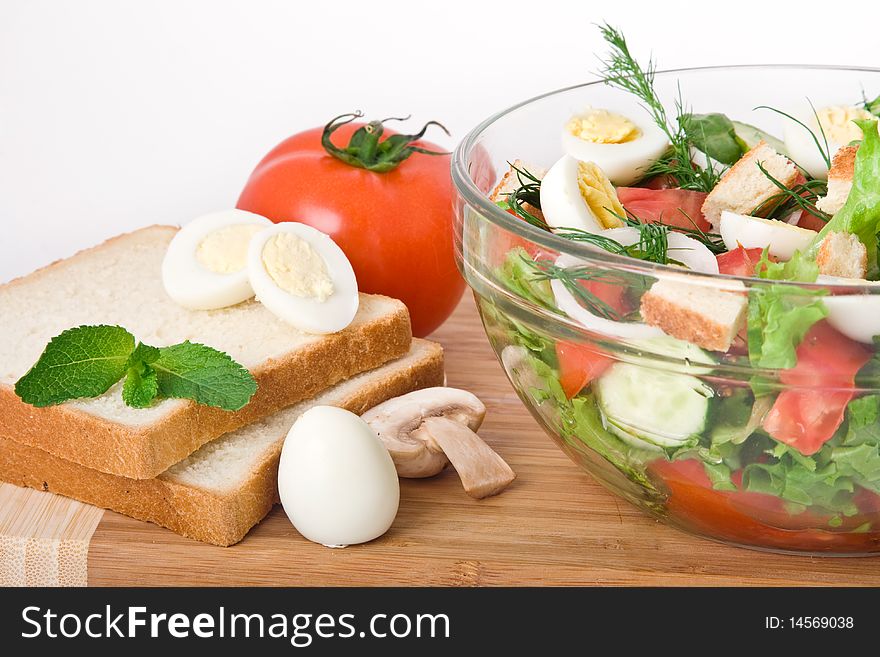 Fresh raw vegetable salad in glass bowl