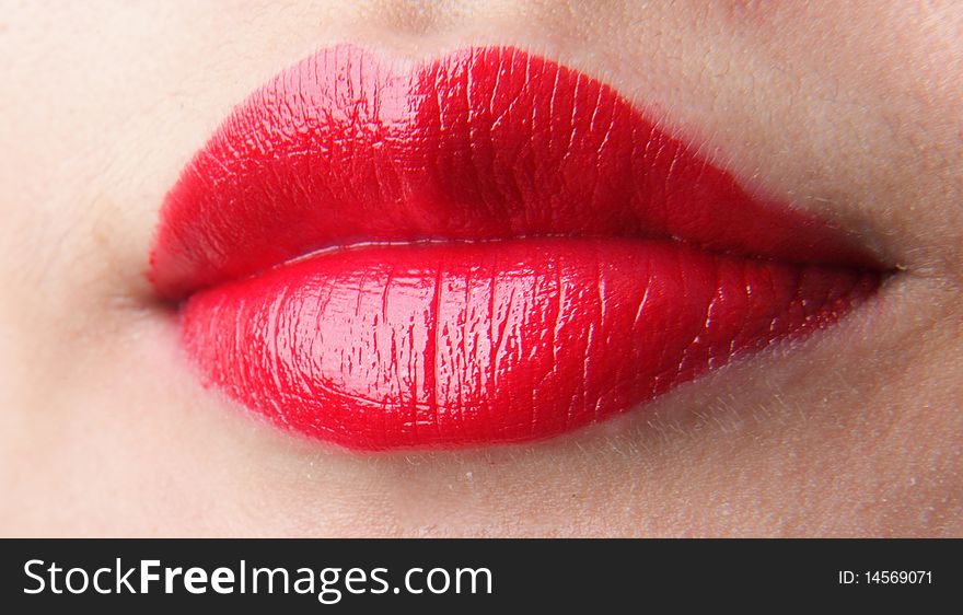 Female lips with red lip gloss