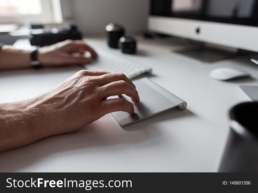 Professional Designer Man Working At The Computer. Closeup Of Male Hands  And White Desktop.