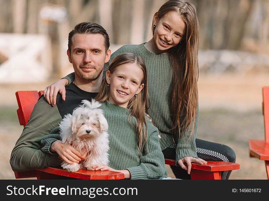 Family with cute puppy outdoor in the park. Family with cute puppy outdoor in the park