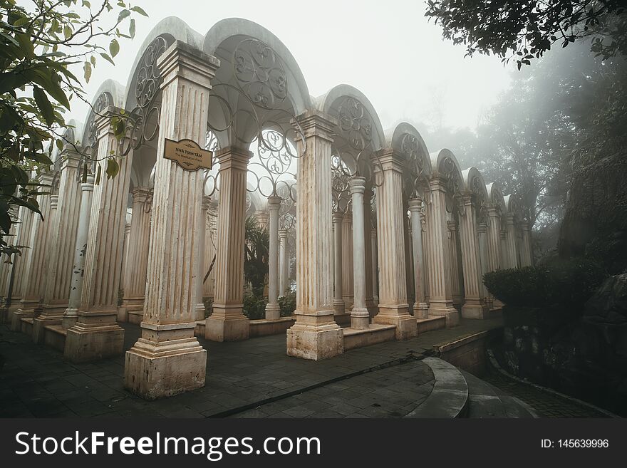 Place for meditation in the forest. An old architectural structure in the Park in front of the colonial castle on mount Bana hill