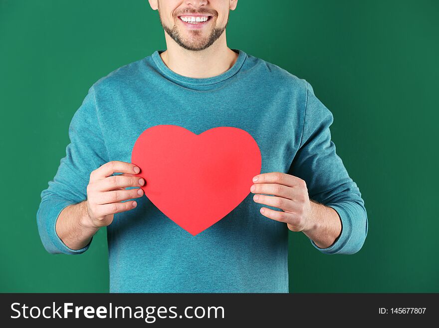 Man With Decorative Heart On Color Background