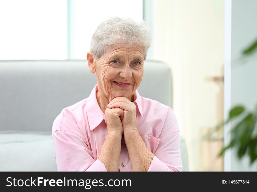 Portrait of beautiful grandmother in living room