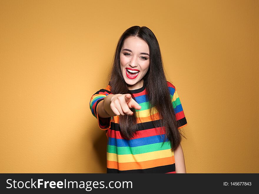 Portrait of beautiful young woman on colorful background