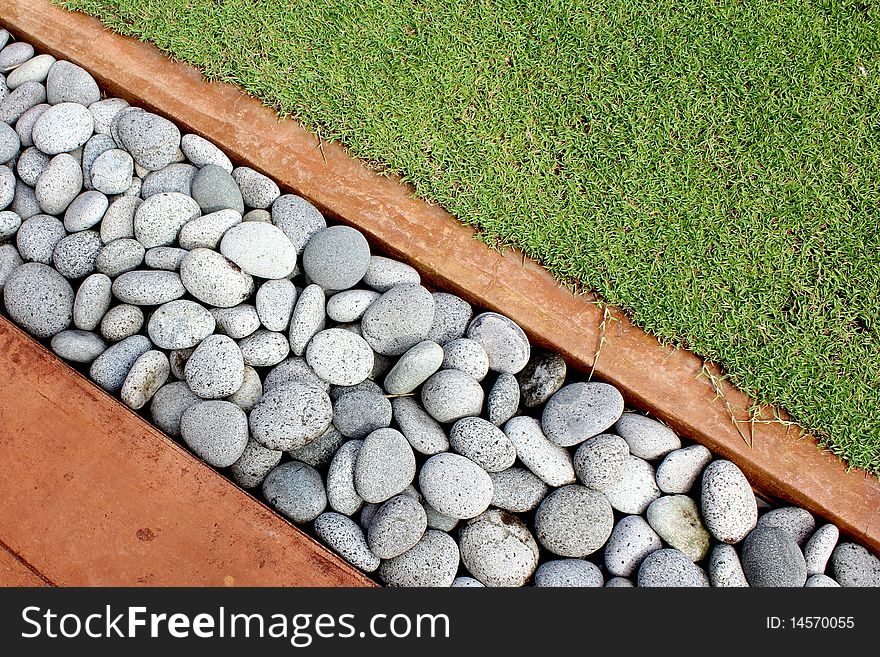 Details of a grass, pebbles and stone background. Details of a grass, pebbles and stone background