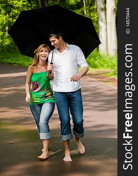 Couple standing in park on rainy summer days. Couple standing in park on rainy summer days