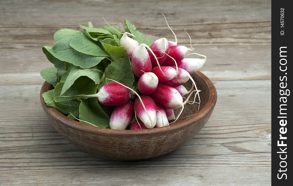 A Bunch Of Fresh Homegrown Radish In A Wooden Bowl On A Wooden Kitchen Table. A Bunch Of Fresh Homegrown Radish In A Wooden Bowl On A Wooden Kitchen Table