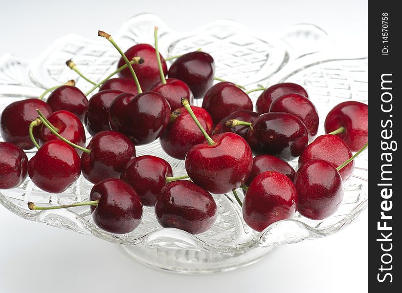 Fresh Cherries In A Glass Dish On A White Background