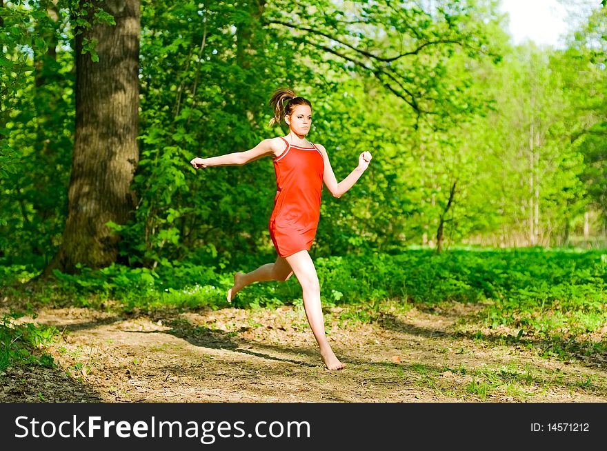 Young woman running in forest. Young woman running in forest