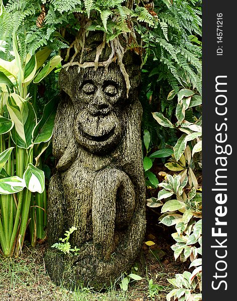 Garden monkey ornamental sculpture in foliage