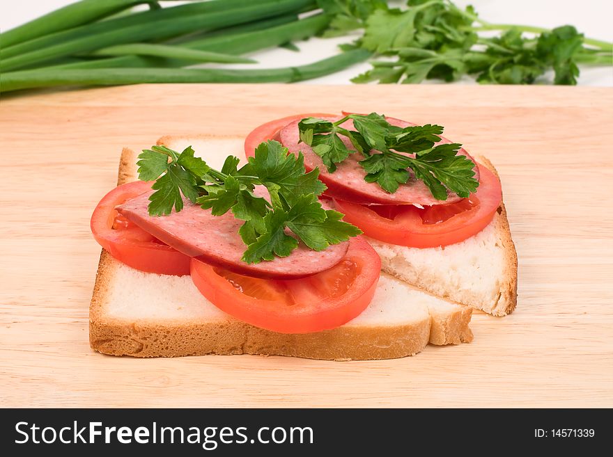 Tasty sandwiches with sausage, tomatoes and herbs